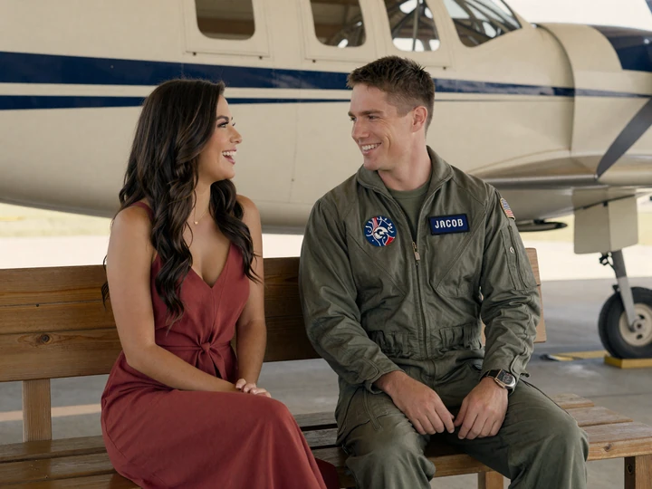 Aviator dating site couple laughing together on a wooden bench at an American military airfield